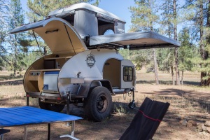 Sleeping family of 4 in roof top tent on top of teardrop camper trailer